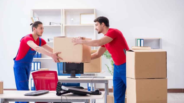 Two contractor employees moving personal belongings